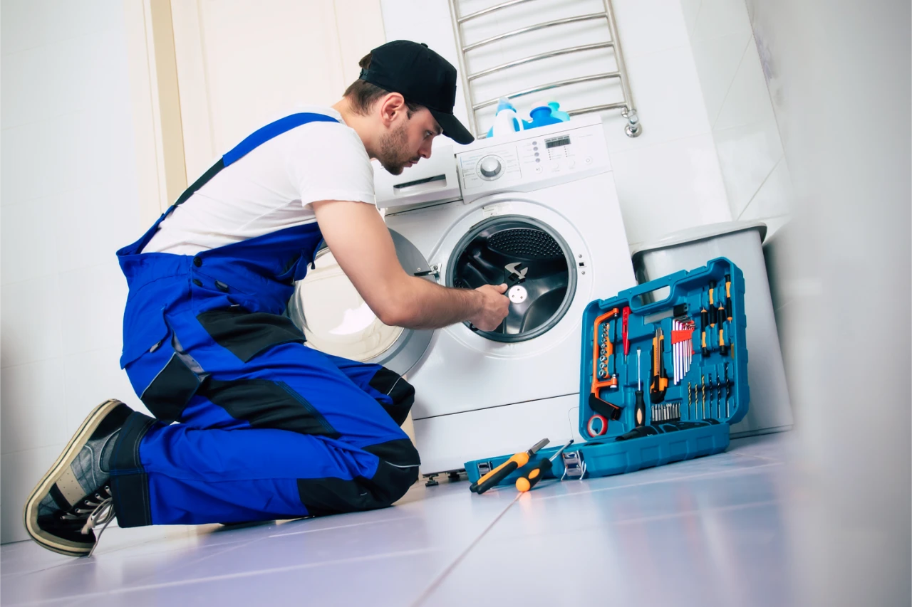 professional-appliance-repairman-fixing-washing-machine